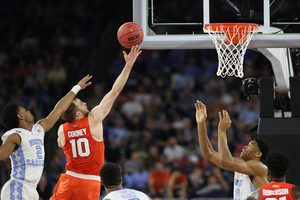 Trevor Cooney leaps toward the basket to try for a lay-up against North Carolina in the Final Four Saturday night.